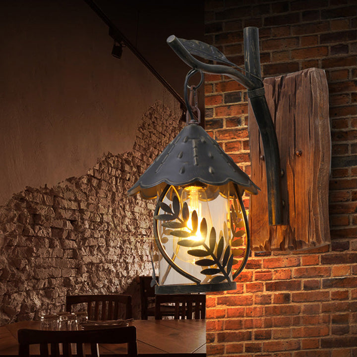 BowLift | A wall lamp with a glass bulb and cylindrical shade made of clear glass, industrial wall lamp for the living room with leaf branch in black