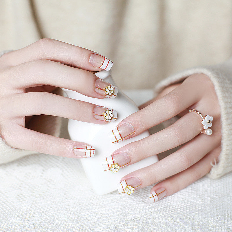 Artificial nails with elegant 3D flower accents and gold trim Bowlift