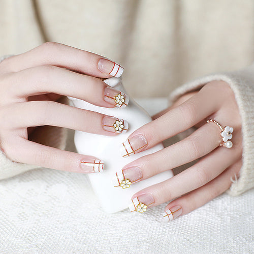 Artificial nails with elegant 3D flower accents and gold trim Bowlift