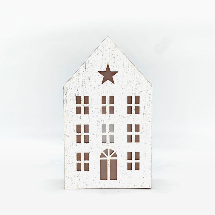 Christmas wooden house with lighting as table decoration