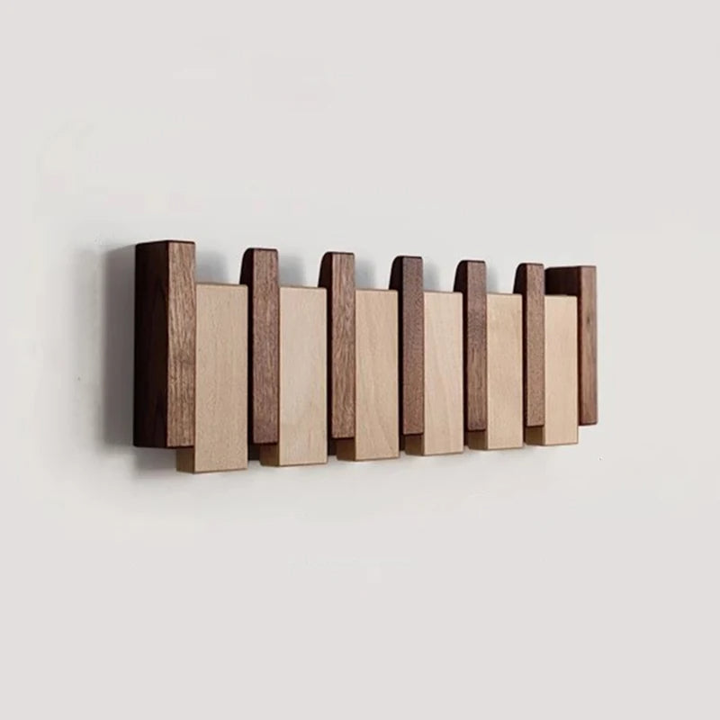Wooden coat rack in piano design with foldable hooks | Bowlift