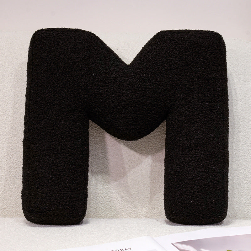 Plush cuddle pillow with letter and heart motifs