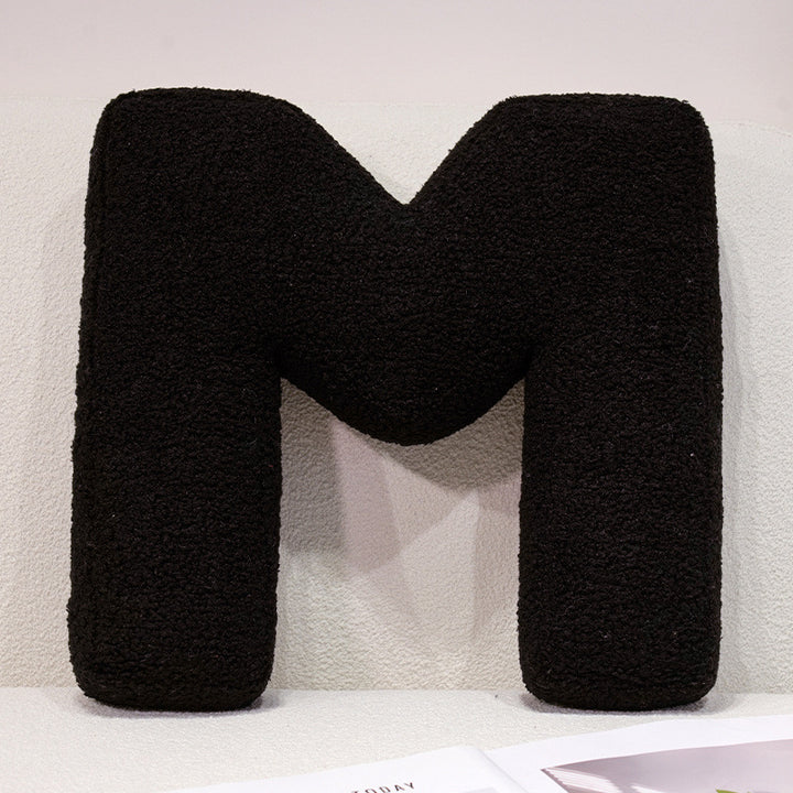 Plush cuddle pillow with letter and heart motifs