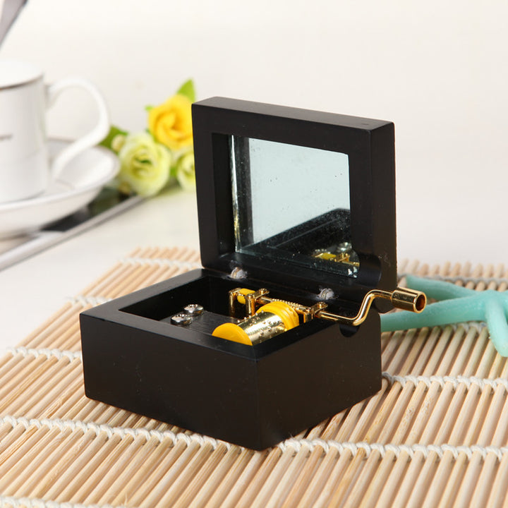 Wooden music box with hand crank