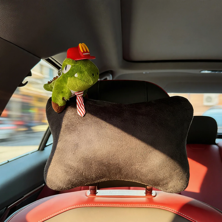 Car headrest with dinosaur design
