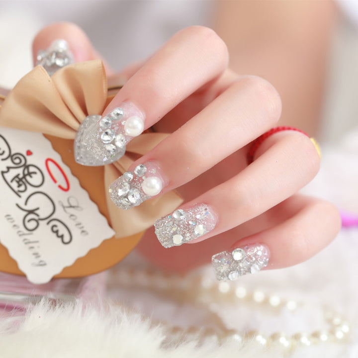 Art nails with glitter and pearl accents Bowlift