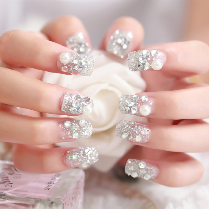 Art nails with glitter and pearl accents Bowlift