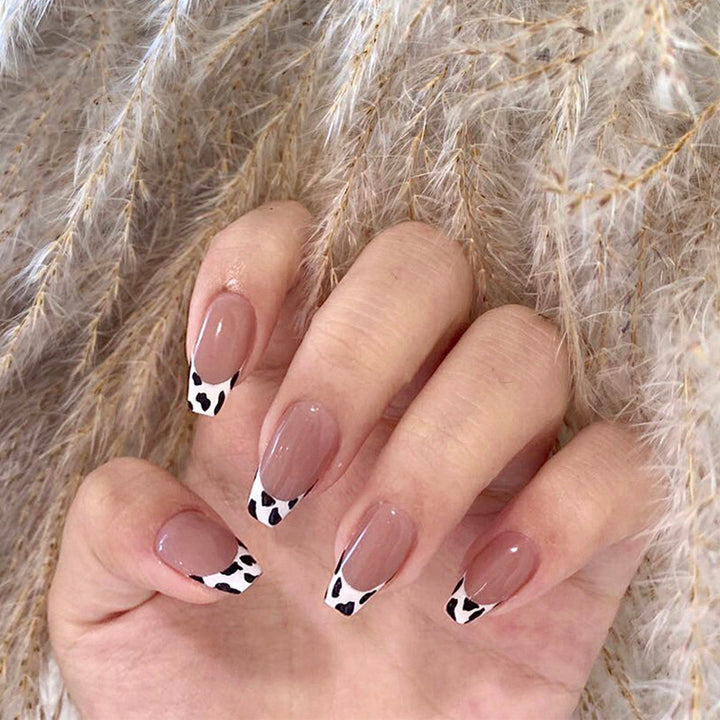 Stylish nail extensions in modern cow print style Bowlift
