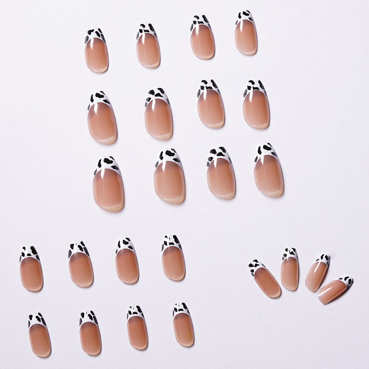Stylish nail extensions in modern cow print style Bowlift
