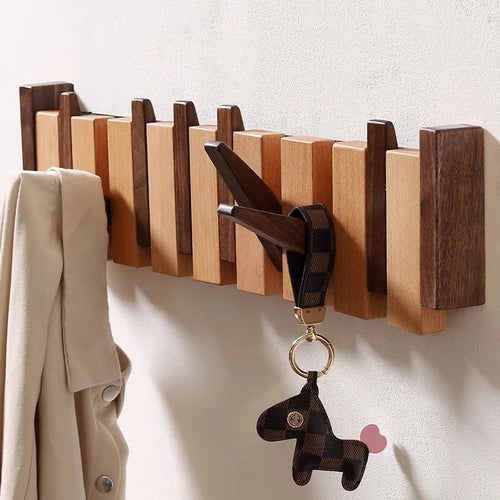 Wooden coat rack in piano design with foldable hooks | Bowlift