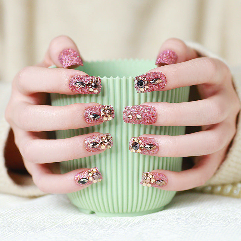 Glamorous artificial nails with glitter and jewelry decoration Bowlift