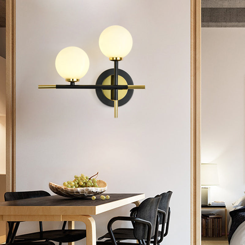 BowLift | Milk glass orb wall light with cross design 2 lights modern black and brass wall light