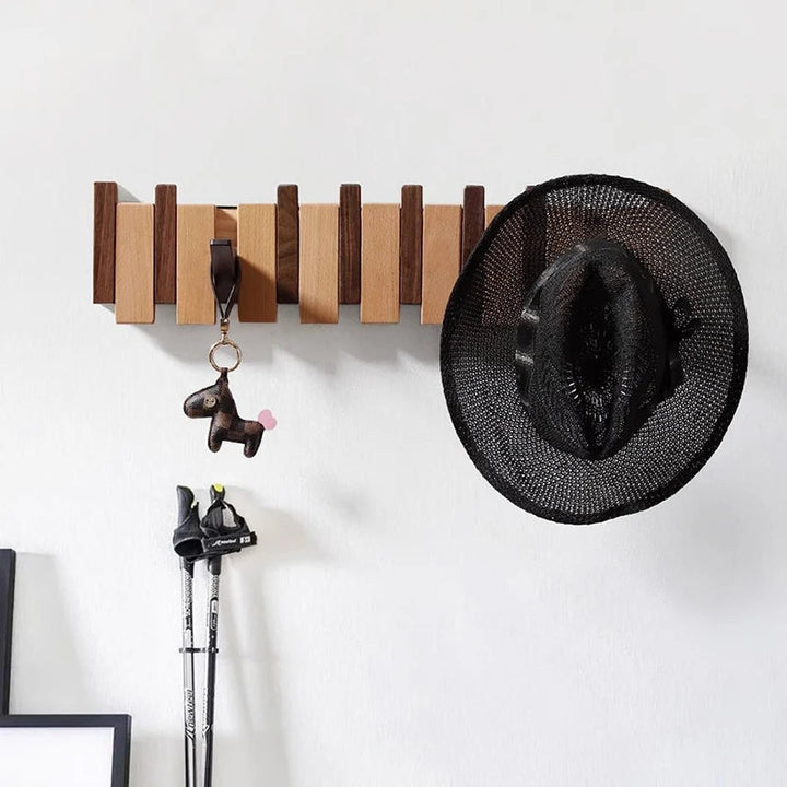 Wooden coat rack in piano design with foldable hooks | Bowlift