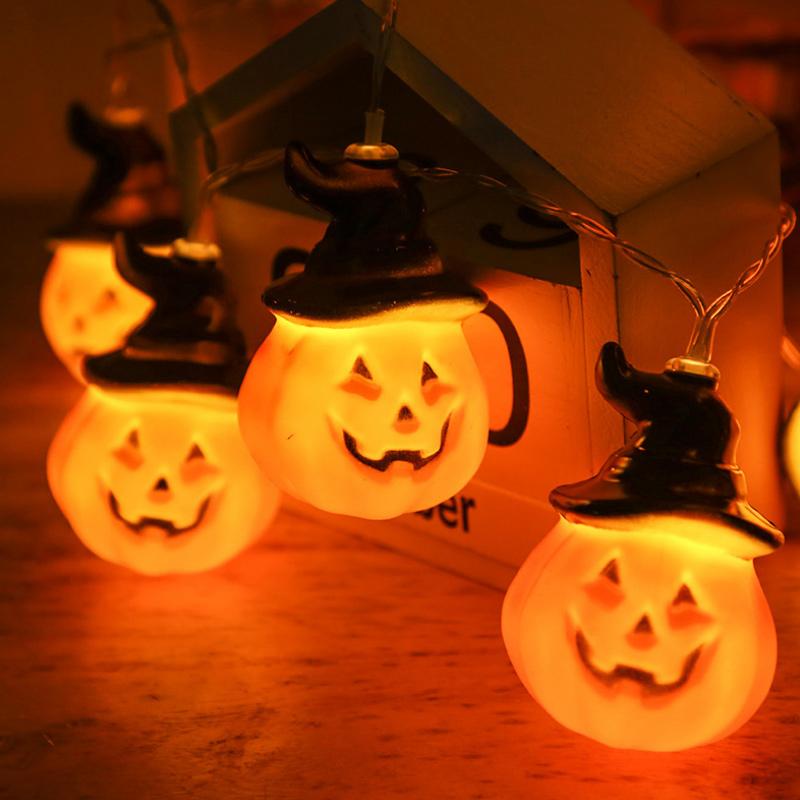 Glowing pumpkin garland Halloween with witch hats | Bowlift