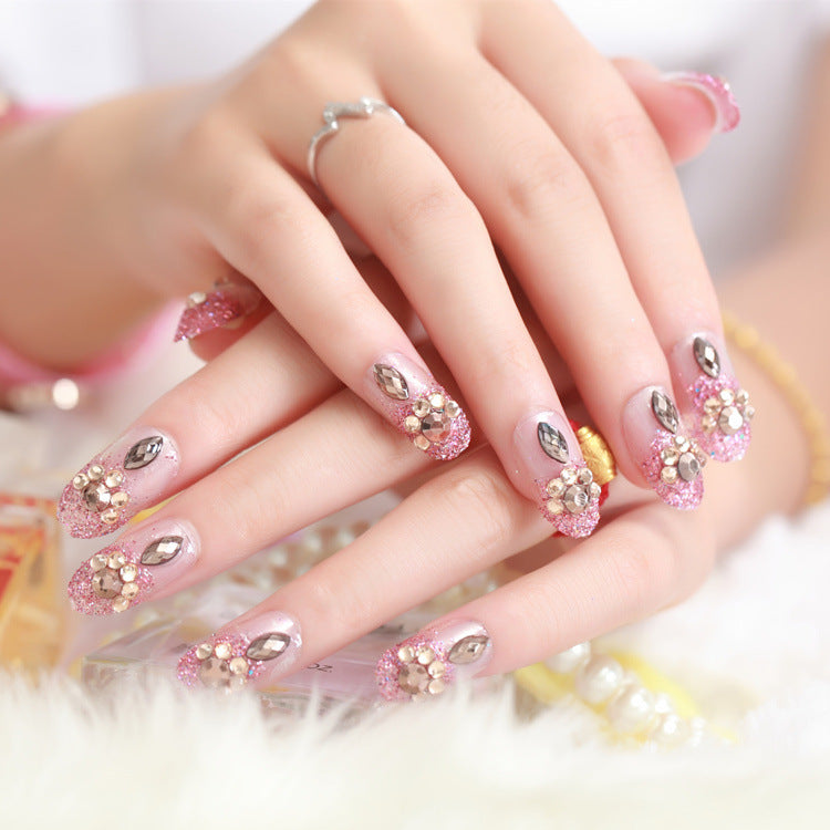 Glamorous artificial nails with glitter and floral elements Bowlift