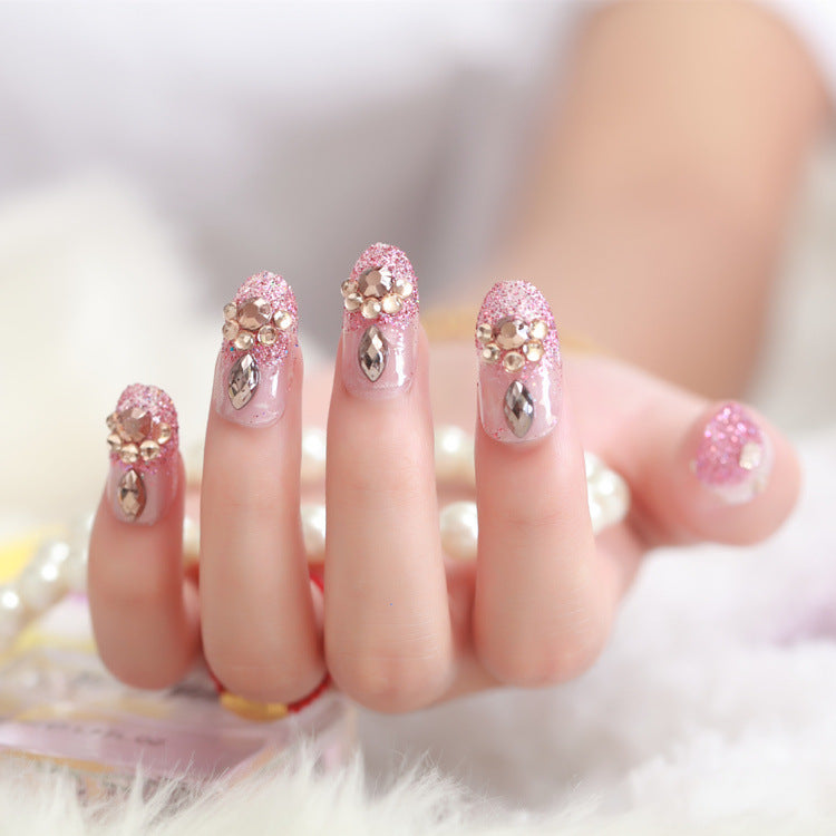 Glamorous artificial nails with glitter and floral elements Bowlift