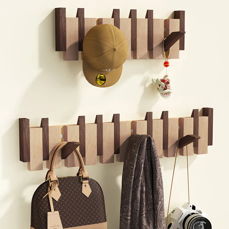 Wooden coat rack in piano design with foldable hooks | Bowlift