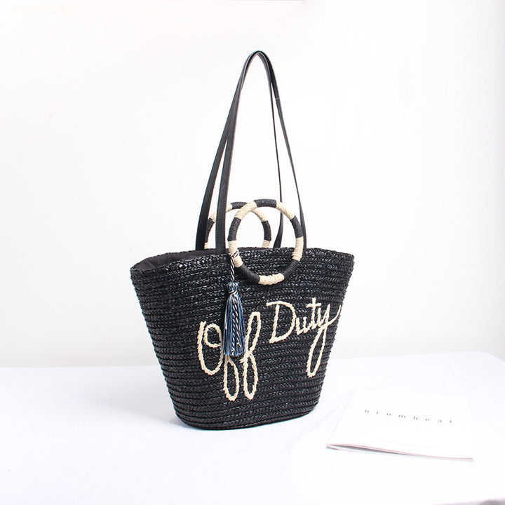 Designer shoulder bag with playful lettering and decorative tassel detail Bowlift
