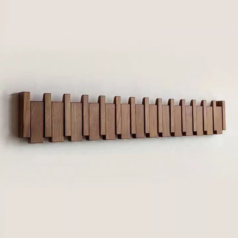 Wooden coat rack in piano design with foldable hooks | Bowlift