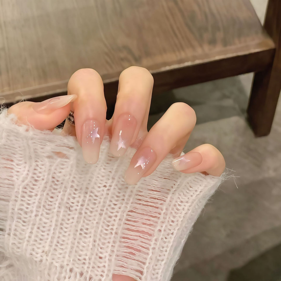 Artificial nails with sparkling stars and gentle gradient Bowlift