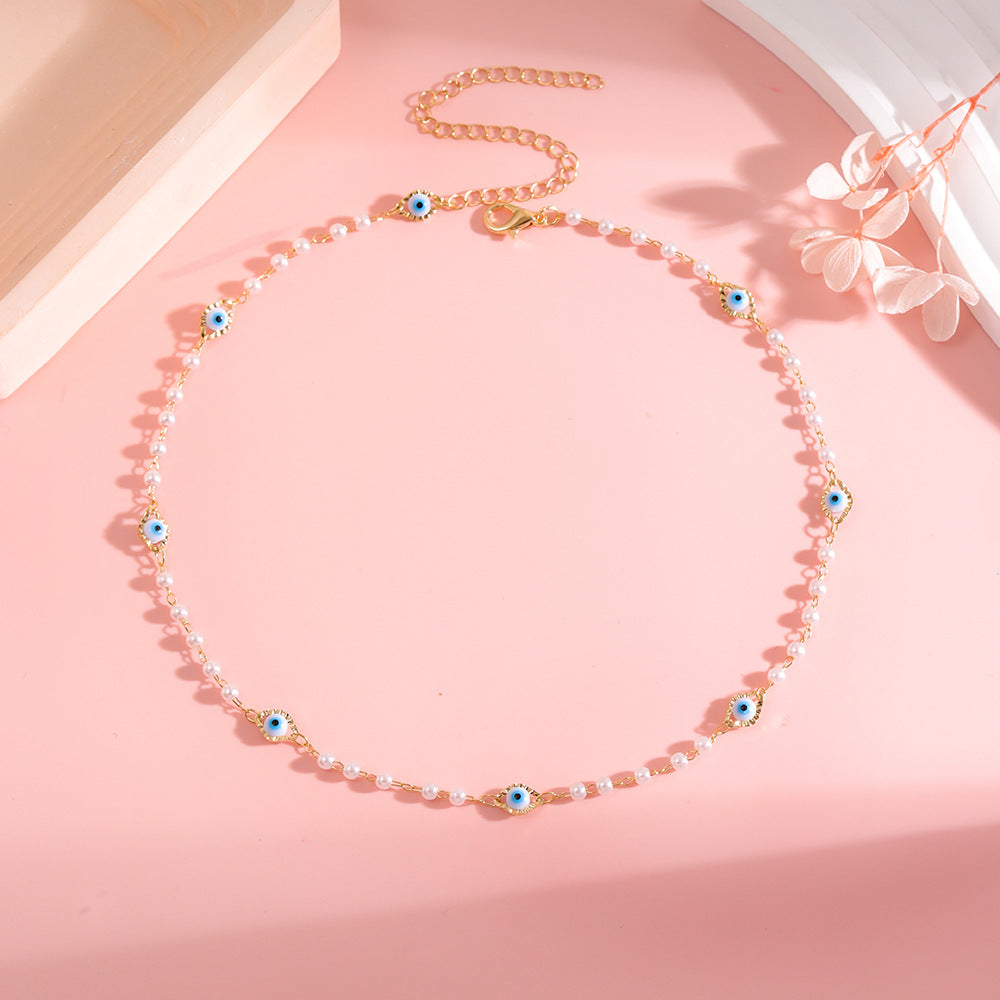 Elegant Pearl and Eye Charm Necklace Bowlift