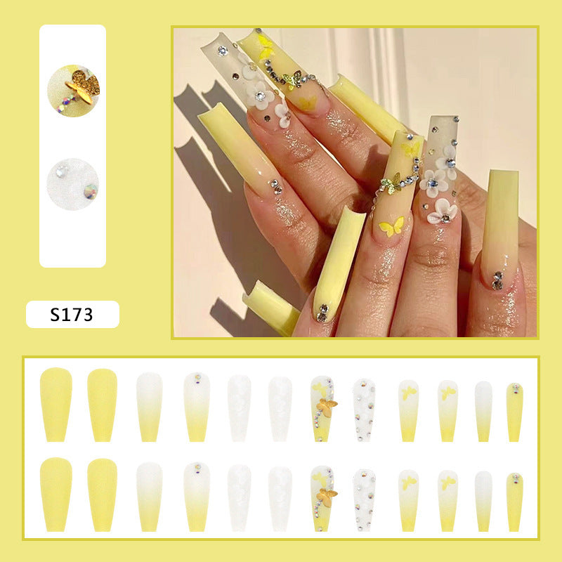 Artificial nail extensions with floral accents and rhinestones Bowlift