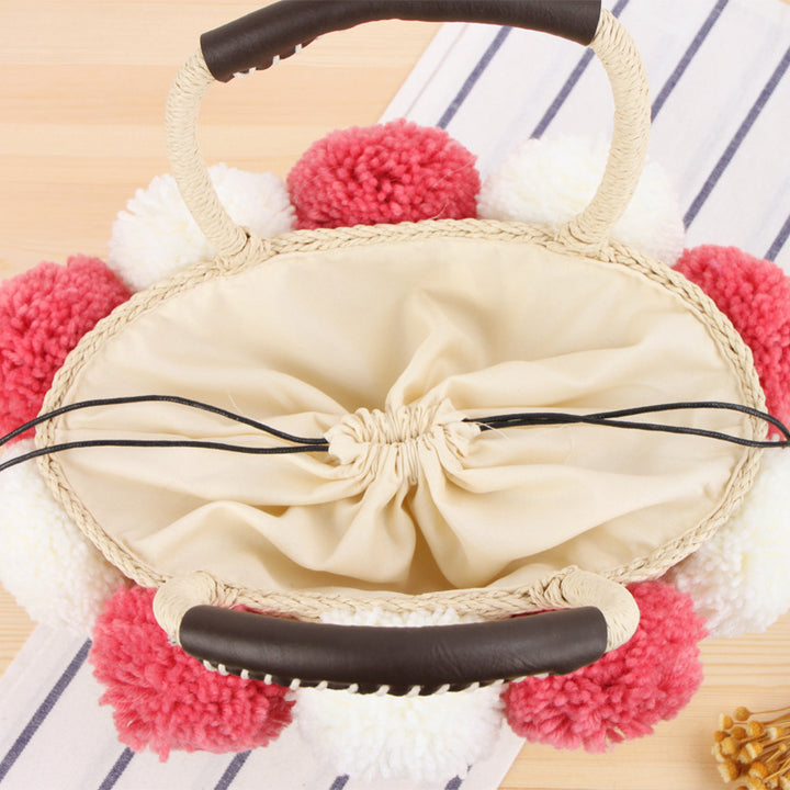 Basket bag with pompom decorated top edge Bowlift