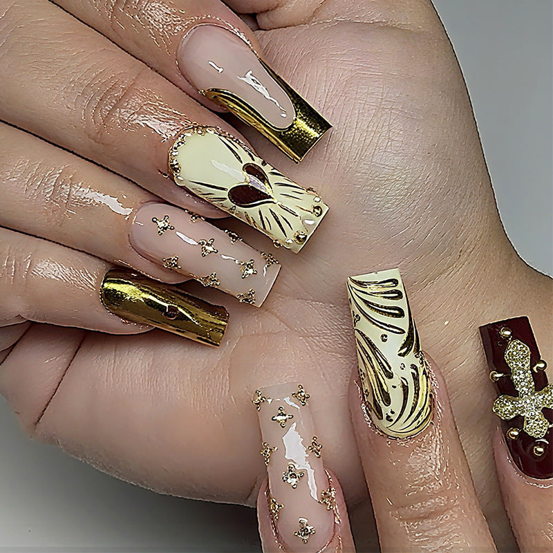 Acrylic nail set with luxurious golden accents and sparkling embellishments Bowlift