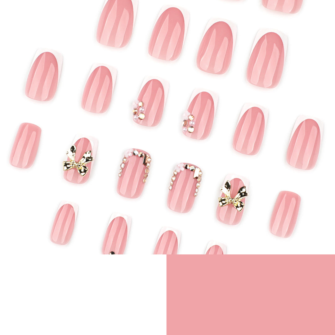 Elegant Nail Extensions with French Tips and Decorative Accents Bowlift