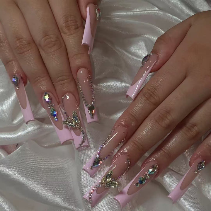Acrylic nail set with elegant glitter and rhinestone accents Bowlift