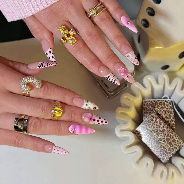 Artistic Press-On Nail Design with Unique Patterns and Rhinestone Accents Bowlift