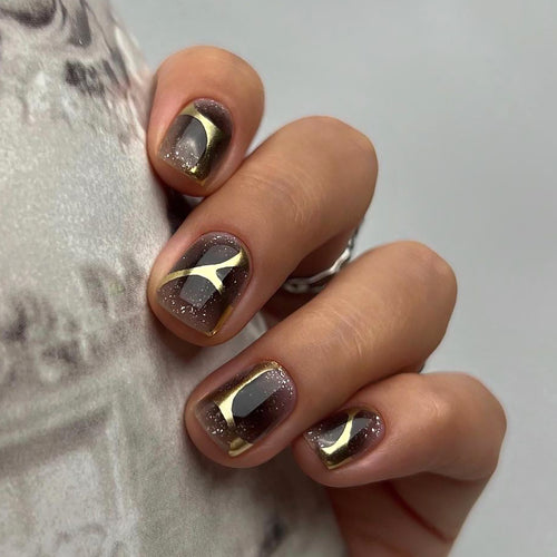 Artificial nail art with elegant metallic design and glitter accents Bowlift
