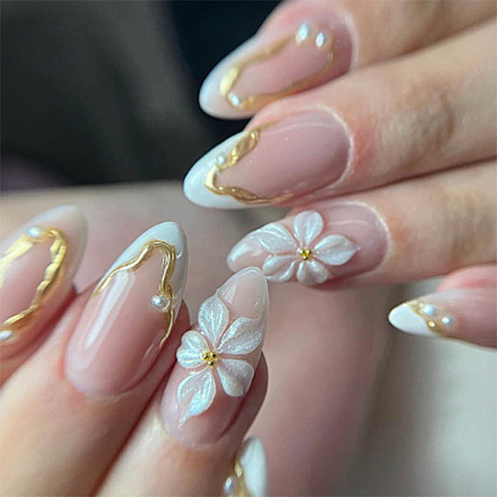 Artificial nail set with elegant gold accents and floral decorations Bowlift