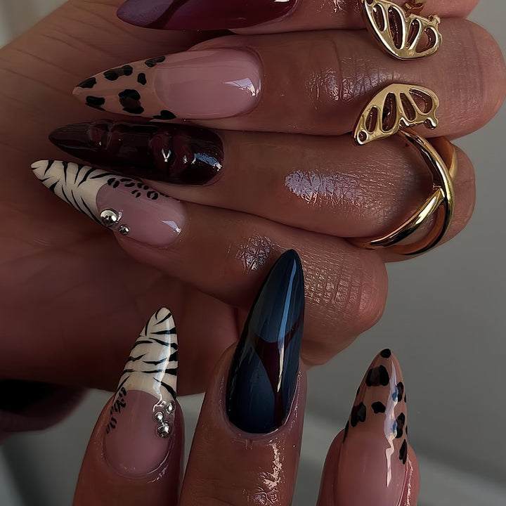Artistic Stiletto Nail Enhancements with Trendy Animal Print and Gem Accents Bowlift