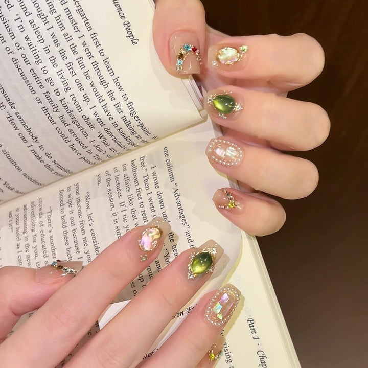 Artificial nails with rhinestone and pearl accents Bowlift