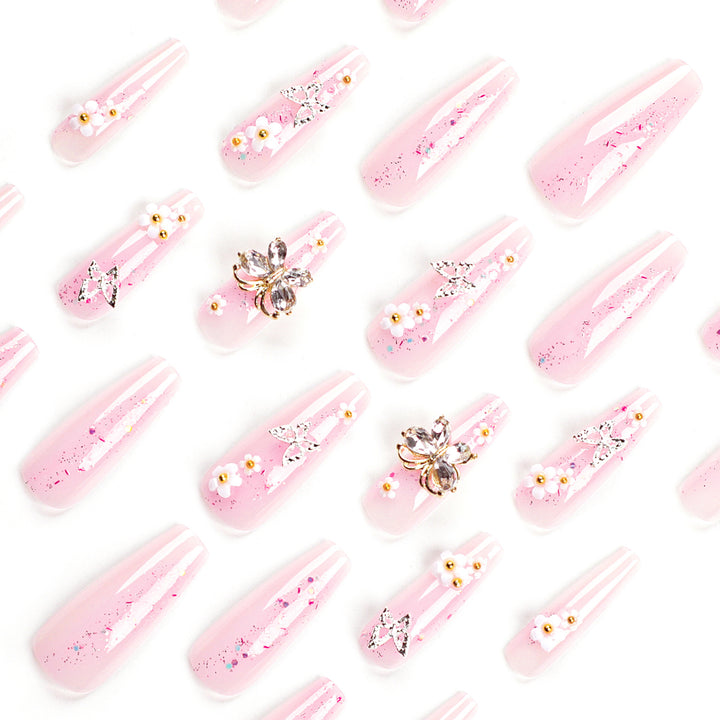 Artistic Nail Extensions with Glitter and Floral Accents Bowlift