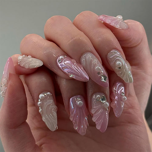Artificial nail art with elegant swirl design and pearl embellishments Bowlift