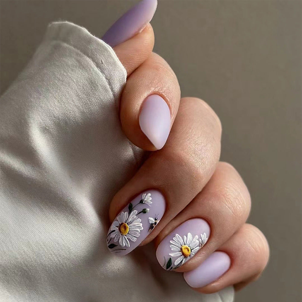 Artistic nail design with delicate floral elements Bowlift