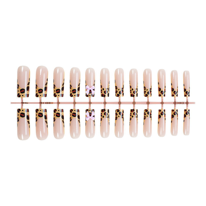 Decorative Stiletto Press-On Nail Art with Animal Print and Bow Accents Bowlift