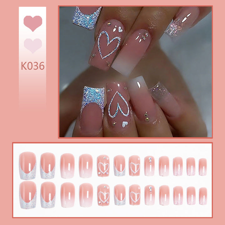 Artificial nails with sparkling heart designs and glitter details Bowlift