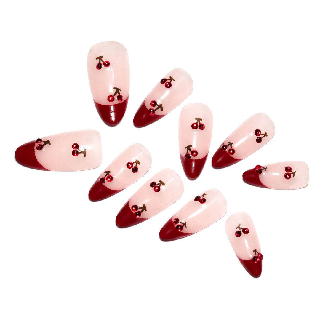 Artful stiletto nails with cherry motifs and glitter accents Bowlift