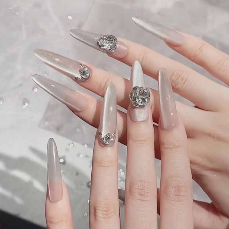 Acrylic nail set with elegant tips and glamorous rhinestone accents Bowlift