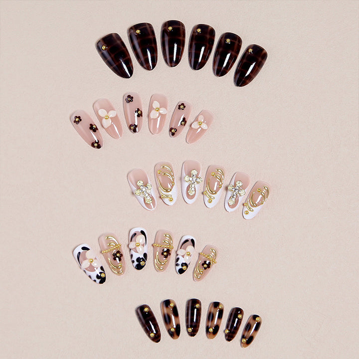 Artificial nails set with elegant gold accents and floral embellishments Bowlift
