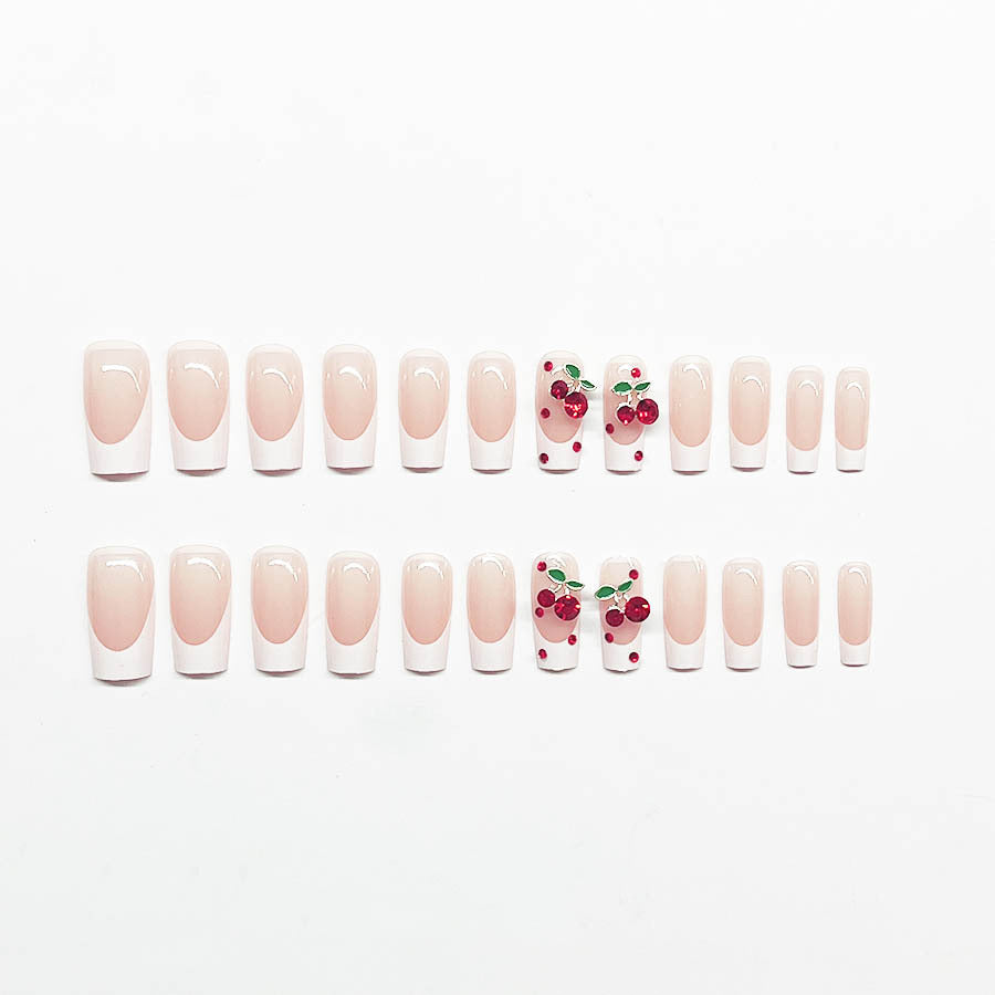 Acrylic nail set with chic cherry motifs and elegant French tip Bowlift