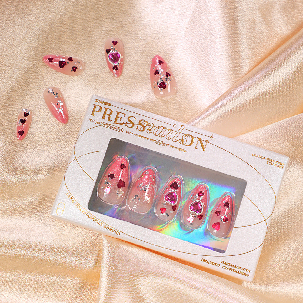 Artful nail art with playful heart designs and glitter Bowlift