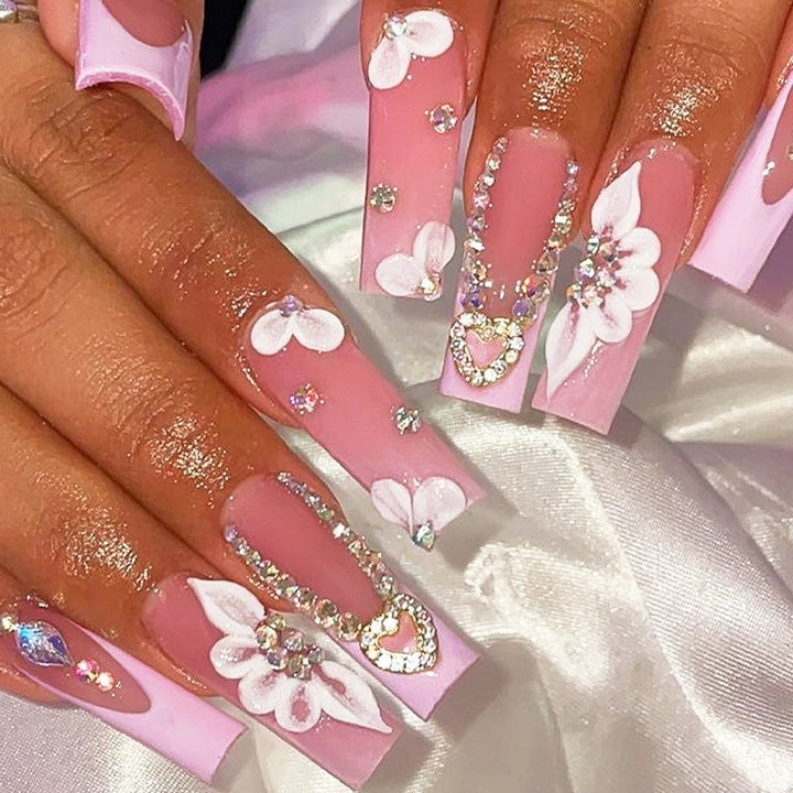 Glamorous artificial nail set with sparkling rhinestones and cross decorations Bowlift