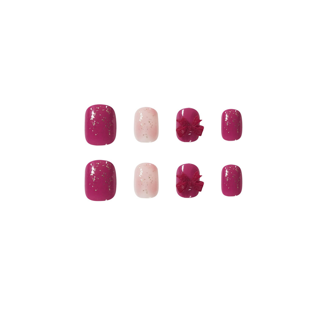 Artificial nail art with glitter embellishments and cute bow motif Bowlift