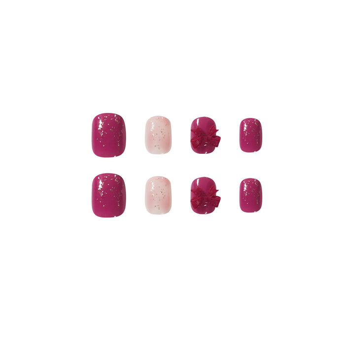 Artificial nail art with glitter embellishments and cute bow motif Bowlift