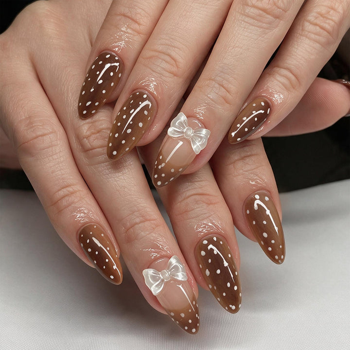 Artistic stiletto nails with delicate bow motif Bowlift
