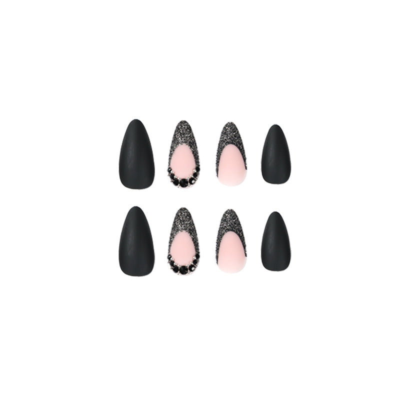 Artful stiletto nails with elegant black design and glitter accents Bowlift